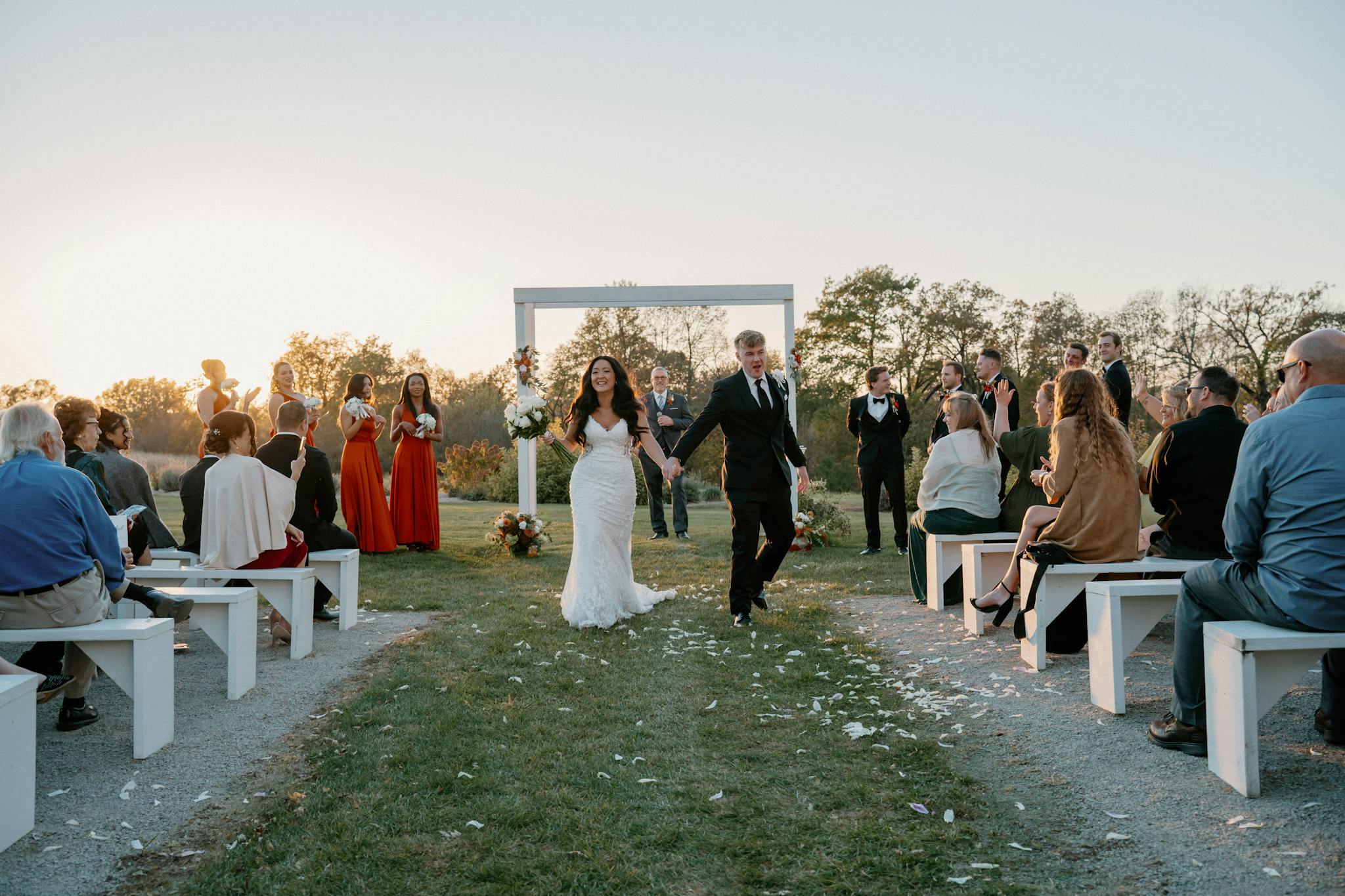Beautiful Outdoor Wedding Ceremony at Sunset with Excited Newlyweds.