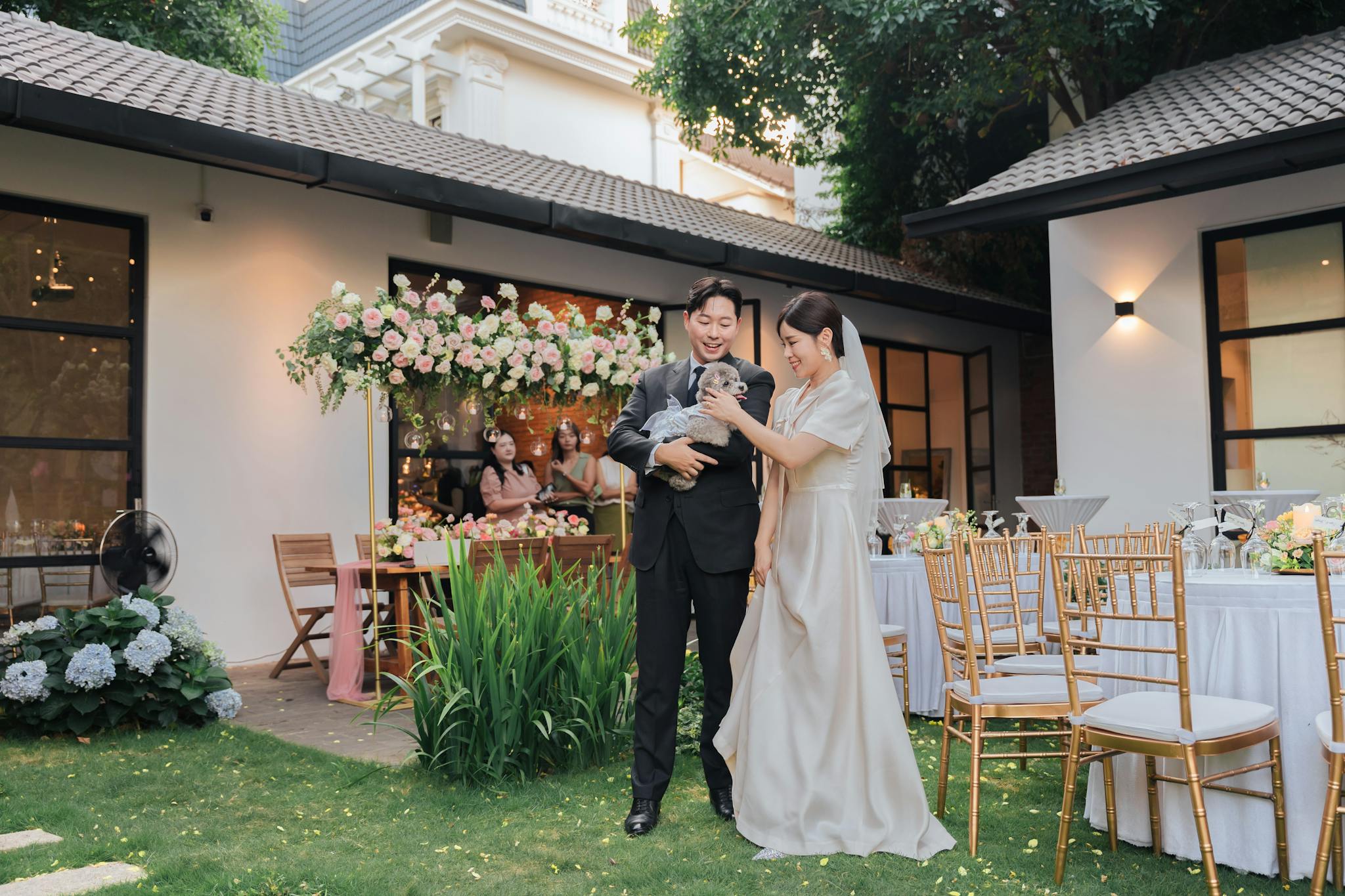 Charming outdoor wedding scene with happy couple, elegant decor, and lush greenery.