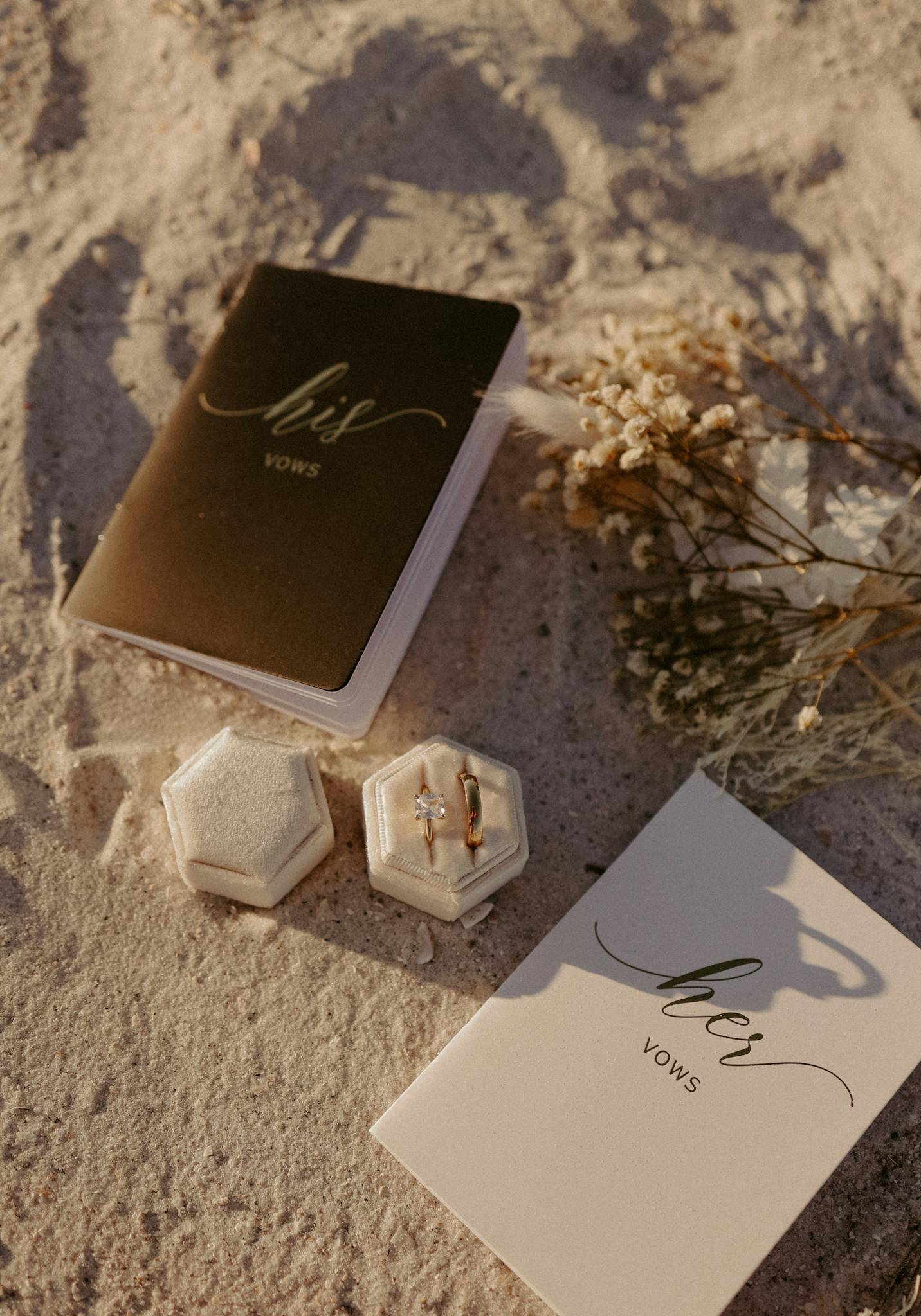 Elegant wedding vow books and rings on sandy St. Pete Beach, perfect for a romantic ceremony.